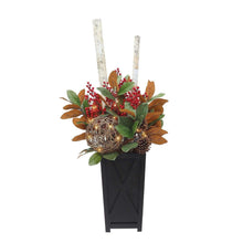 Pre-lit decorative topiary in black planter with red berries, pinecones, and warm gold glow