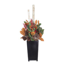 Decorative topiary in black planter with red berries, orange leaves, pinecone and twigs