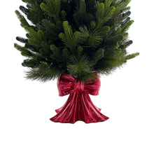 Pre-lit pine topiary with glossy red bow at the base