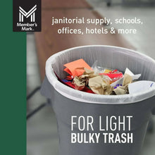 White plastic can liner holding light bulky trash inside a trash can