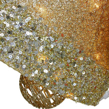 Gold glitter bell fabric detail with reflective pieces and red sparkly accents