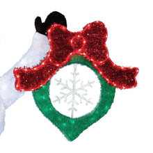 Glowing red-bow wreath ornament with green glitter heart and white snowflake center