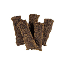 Beef jerky dog treats of stacked thin dark strips