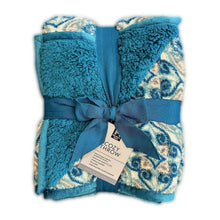 Cozy throw blanket in blue plush with patterned panel and ribbon bow