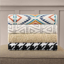 Cozy throw blanket layers, patterned white with tan and black houndstooth