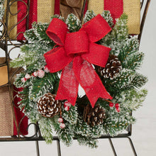 Pre-lit pine topiary wreath with large red burlap bow and pinecones