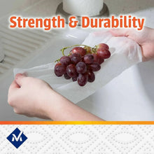 Hands holding a white paper towel sheet to pat grapes dry