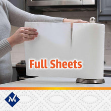 White full sheet paper towels being pulled from dispenser by a person
