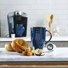Coffee pod mug with caramel vanilla cream, pastries and vanilla bean accents