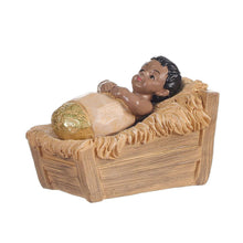 Nativity set baby figurine reclining in a carved wooden manger with rounded edges.