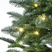 Pre-lit pine branches with warm LED lights on artificial evergreen foliage