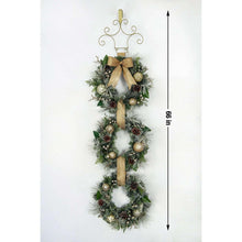 Pre-lit three-tier wreath door hanger with gold bow, gold baubles, and green pine