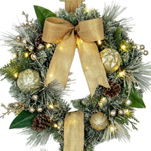 Close-up of pre-lit wreath door hanger with gold ribbon bow and pine garland