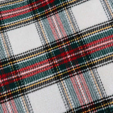 Tartan plaid fabric close-up with black, white, red, and green checks
