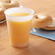 Translucent plastic cup with pale yellow drink