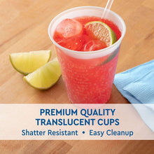 Translucent plastic cup with red iced drink and lime wedge