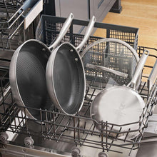 Stainless steel nonstick frying pans loaded in dishwasher rack