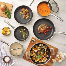 Nonstick cookware set with stainless pans featuring dark interior surfaces