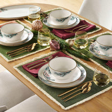 Holiday stoneware dinnerware set with round plates and bowls, green-and-gold accents