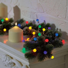 Multi-color LED berry light string wrapped around an evergreen wreath