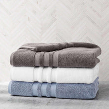 Bath sheet stack in Arctic White, Blue Crest, and Zinc, rolled towels