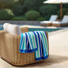 Oversized beach towel with multicolor blue and teal vertical stripe pattern