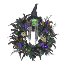 Pre-lit witch wreath close view with glowing green witch face and purple light bulbs