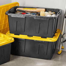 Black and yellow storage tote with open top, filled with tools and supplies