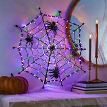 Pre-lit black spiderweb with four spiders and multicolor LED lights