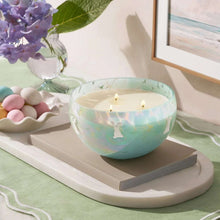 Turquoise glass 3-wick candle with bunny silhouette icon on the bowl