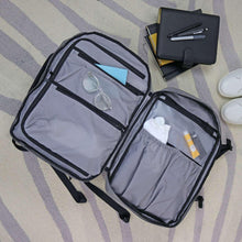 Gray travel backpack open with front zip pocket and interior organizers