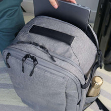 Gray travel backpack with front zip compartment and adjustable shoulder straps