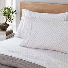 White printed sheet set with small repeating diamond dot pattern on pillowcases and top sheet