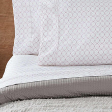 White printed sheet set with subtle red dot pattern on pillowcase and top sheet