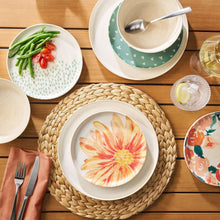 Round woven water hyacinth placemat with dark rim, centered on table.