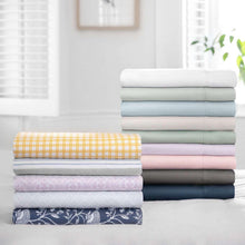 Assorted color sheet set folds in white, blue, gray, pink, and navy