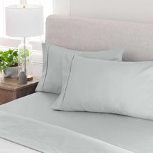 Light gray sheet set with two pillowcases and flat sheet, neatly styled