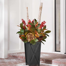 Pre-lit decorative topiary in black planter with red berries, pinecones, and gold lights
