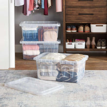 Clear storage tote with lid holding folded fabric
