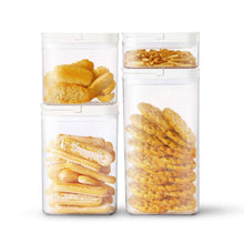 Two clear pantry storage containers with flip-lock lids, filled with snack items