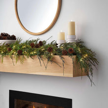 Pre-lit cypress garland with green foliage, pinecones, and warm string lights