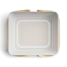 Square white woven basket with wood handles and open top