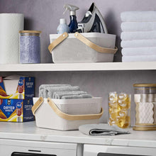 White woven storage basket with wood handles