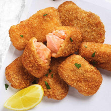 Cooked breaded salmon bites with visible salmon centers, lemon wedges nearby