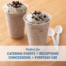 Clear plastic cups with dessert toppings of whipped cream and crumbs