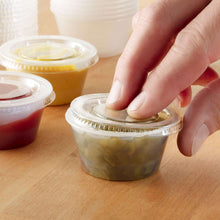Clear plastic lid pressed onto a small disposable food cup