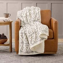 Cozy throw blanket in off-white with black geometric dot pattern