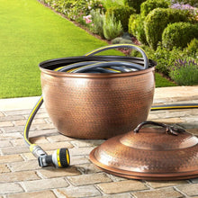 Metal hose storage pot with hinged lid, open for hoses, copper finish