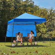 Blue instant canopy tent with peaked roof, metal frame, and open side panels