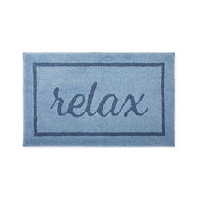 Blue bath mat with 'relax' logo centered